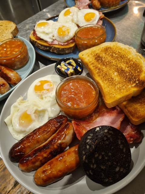 A full English breakfast with sausages, bacon, black pudding, eggs, beans and toast
