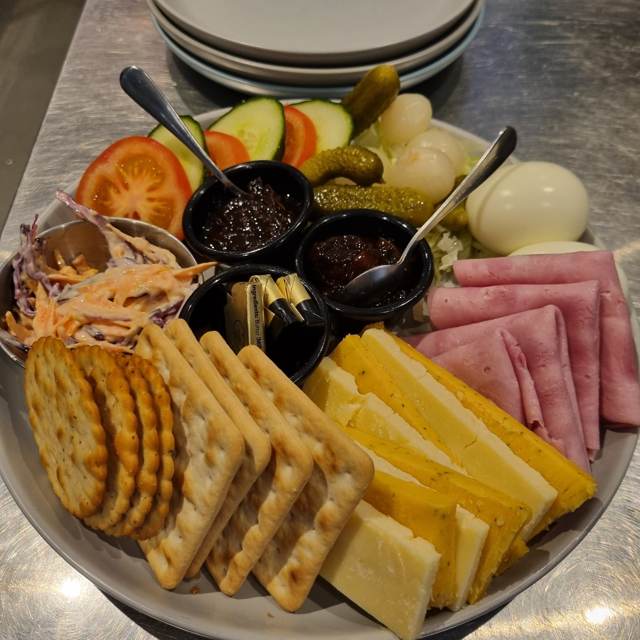 A ploughman’s platter with ham, cheese, crackers, pickles, chutney, boiled eggs and coleslaw