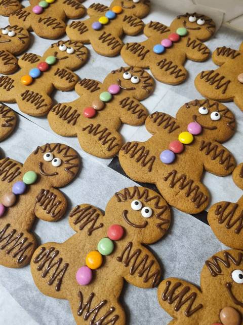 Gingerbread men decorated with chocolate icing, sweets and sugar eyes